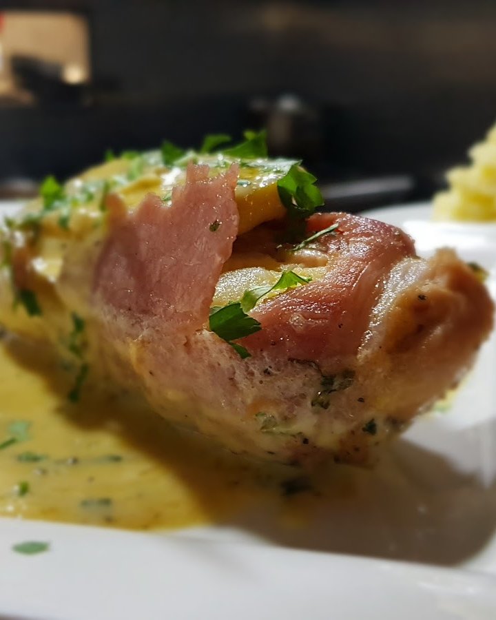A plated dish of prosciutto-wrapped chicken with parsley and mashed potato, from the kitchen at Montos